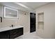 Modern bathroom with a vanity, illuminated mirror, and contemporary fixtures at 2202 S Grape St, Denver, CO 80222