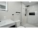 Sleek bathroom featuring a walk-in shower, modern fixtures, and white marble tile, all in a bright, minimalist design at 2202 S Grape St, Denver, CO 80222