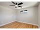 Neutral bedroom with light walls, hardwood floors, a ceiling fan, and a bright window at 2202 S Grape St, Denver, CO 80222