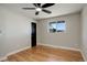 Bedroom with hardwood floors, black ceiling fan, and trim, offers a modern and comfortable space at 2202 S Grape St, Denver, CO 80222