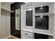 Custom walk-in closet with built-in shelving, drawers, and black accent paneling for organized storage at 2202 S Grape St, Denver, CO 80222
