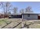 Charming single-story home with brick facade, covered patio, and well-manicured lawn at 2202 S Grape St, Denver, CO 80222