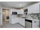 Beautifully remodeled kitchen with white cabinets, stainless steel appliances, and mosaic tile backsplash at 2202 S Grape St, Denver, CO 80222