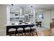 Charming kitchen with a breakfast bar, stainless steel appliances, and white cabinetry at 2202 S Grape St, Denver, CO 80222