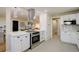 Bright kitchen with white cabinetry, stainless steel appliances, and modern pendant lighting at 2202 S Grape St, Denver, CO 80222