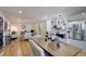 Open floor plan featuring a dining area flowing into a well-lit living room with hardwood floors at 2202 S Grape St, Denver, CO 80222