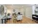 Bright living room features wood floors, neutral walls, and modern decor with access to the open kitchen and dining area at 2202 S Grape St, Denver, CO 80222