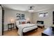 Comfortable bedroom features modern lighting, a soft color palette, and light hardwood flooring at 2202 S Grape St, Denver, CO 80222