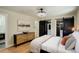 Bright main bedroom features hardwood flooring, custom closet, and ensuite bath at 2202 S Grape St, Denver, CO 80222