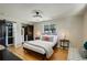 Cozy bedroom boasts a custom closet system, modern lighting, and light hardwood flooring at 2202 S Grape St, Denver, CO 80222