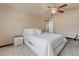 Bright bedroom with a queen bed, ceiling fan, and neutral decor at 11208 Eagle Creek Cir, Commerce City, CO 80022