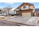 Two-story house with tan and burnt orange siding, attached garage, and landscaping at 11208 Eagle Creek Cir, Commerce City, CO 80022