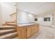 Basement with staircase, cabinets, and a neutral carpet at 13314 Spruce Creek Cir, Larkspur, CO 80118