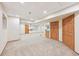 Open finished basement space with carpeting, storage, and multiple doorways at 13314 Spruce Creek Cir, Larkspur, CO 80118