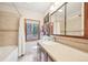 Bathroom with a combination shower/tub and a large mirror over the sink at 13314 Spruce Creek Cir, Larkspur, CO 80118