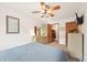 Bedroom with ceiling fan, view to a closet, dresser, and a blue bedspread at 13314 Spruce Creek Cir, Larkspur, CO 80118