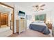 Bedroom features a ceiling fan, neutral color walls, and a view to trees at 13314 Spruce Creek Cir, Larkspur, CO 80118