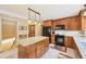 Kitchen with a center island, black appliances, wood cabinets and countertops at 13314 Spruce Creek Cir, Larkspur, CO 80118