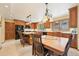 Eat-in kitchen with granite countertops, stainless steel appliances, an island, and wooden cabinets at 13314 Spruce Creek Cir, Larkspur, CO 80118