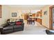 Open concept living room and kitchen with hardwood cabinets and floors and comfortable seating at 13314 Spruce Creek Cir, Larkspur, CO 80118