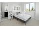Neutral bedroom featuring a cozy bed, stylish decor, and a window with natural light at 1678 Tabor St, Lakewood, CO 80215