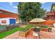Outdoor dining on patio with raised garden beds and some shade provided by an umbrella at 274 S Lincoln St, Denver, CO 80209