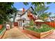 Exterior of two-story home with brick chimney and a flourishing backyard garden at 274 S Lincoln St, Denver, CO 80209