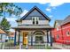 Charming two-story home featuring a welcoming front porch, yellow door, and white picket fence at 274 S Lincoln St, Denver, CO 80209