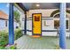 Inviting front porch featuring a yellow door, detailed columns, and a cozy seating area at 274 S Lincoln St, Denver, CO 80209