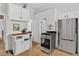 Bright kitchen with light wood floors, white cabinets, and stainless steel appliances at 274 S Lincoln St, Denver, CO 80209
