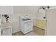 Bright kitchen featuring white appliances, a range, bright cabinets, and tile floors at 274 S Lincoln St, Denver, CO 80209