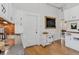 Bright kitchen with light wood floors, white cabinets and a view to dining room at 274 S Lincoln St, Denver, CO 80209