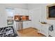 Bright kitchen features stainless appliances, light wood floors and white cabinets at 274 S Lincoln St, Denver, CO 80209
