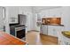 Cozy kitchen with stainless steel appliances, white cabinets, and butcher block countertops at 274 S Lincoln St, Denver, CO 80209
