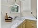 Well-lit kitchen featuring ample counter space, white countertops, and light yellow cabinets at 274 S Lincoln St, Denver, CO 80209