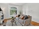 Inviting living room featuring a comfortable sofa, decorative pillows, and ample natural light at 274 S Lincoln St, Denver, CO 80209