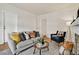Well-lit living room with a stylish sofa, patterned pillows, and hardwood floors at 274 S Lincoln St, Denver, CO 80209