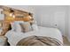 Bedroom with rustic headboard and fluffy pillows at 274 S Lincoln St, Denver, CO 80209