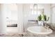 A bright bathroom featuring double sinks, a large mirror, and modern decor at 12490 Kearney Cir, Thornton, CO 80602