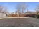 Large fenced backyard featuring a grass lawn and mature trees at 20781 E 48Th Pl, Denver, CO 80249