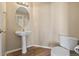 Bathroom with pedestal sink and standard toilet with wood flooring at 20781 E 48Th Pl, Denver, CO 80249