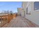 A spacious wooden deck featuring wood railings and access to the home's sliding glass door at 20781 E 48Th Pl, Denver, CO 80249