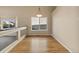 Elegant dining area with hardwood floors, stylish lighting, and scenic views from the large window at 20781 E 48Th Pl, Denver, CO 80249