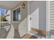Close-up of the front porch with a classic white door, stylish lighting, and tidy landscaping at 20781 E 48Th Pl, Denver, CO 80249