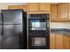 Kitchen featuring a black refrigerator and built-in double oven at 20781 E 48Th Pl, Denver, CO 80249