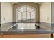 Kitchen cooktop and countertops set under an arched window with neighborhood views at 20781 E 48Th Pl, Denver, CO 80249