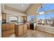 Bright kitchen with wooden cabinets, an island, and a large window, offering a functional and inviting space at 20781 E 48Th Pl, Denver, CO 80249