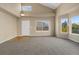 Spacious living room with a high ceiling, large windows, and a combination of carpet and hardwood flooring at 20781 E 48Th Pl, Denver, CO 80249