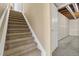 Carpeted stairs lead to basement with unfinished walls and ceiling at 20781 E 48Th Pl, Denver, CO 80249
