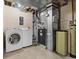 Basement utility room with washer, dryer, water filtration, and furnace at 20781 E 48Th Pl, Denver, CO 80249